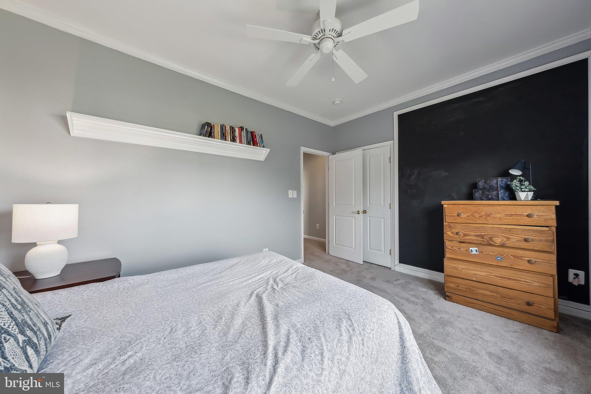 9061 Roaring Spring Loop Bristow, VA 20136 - Photo 45 of 55 a bedroom with a bed and a dresser