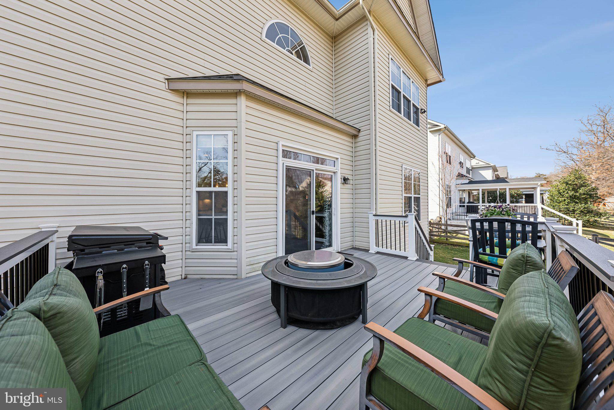 9061 Roaring Spring Loop Bristow, VA 20136 - Photo 47 of 55 a view of a patio with couches chairs and wooden floor