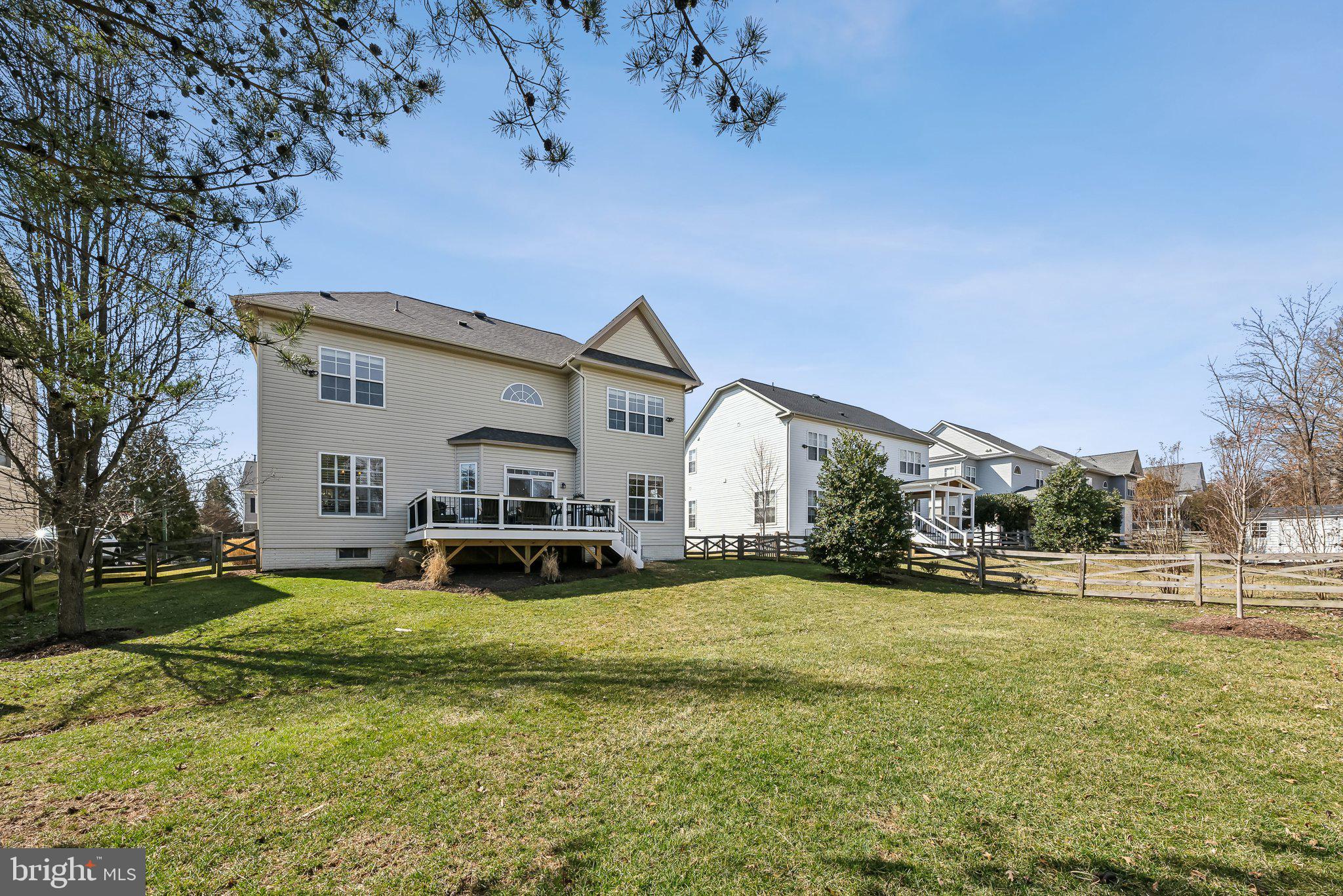 9061 Roaring Spring Loop Bristow, VA 20136 - Photo 49 of 55 a view of a house with a big yard and large trees
