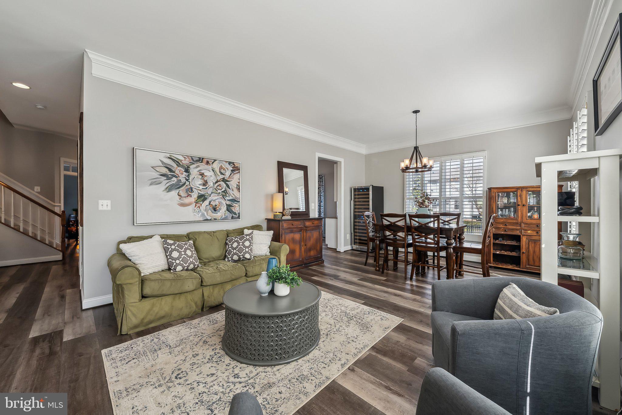 9061 Roaring Spring Loop Bristow, VA 20136 - Photo 5 of 55 a living room with furniture and a chandelier