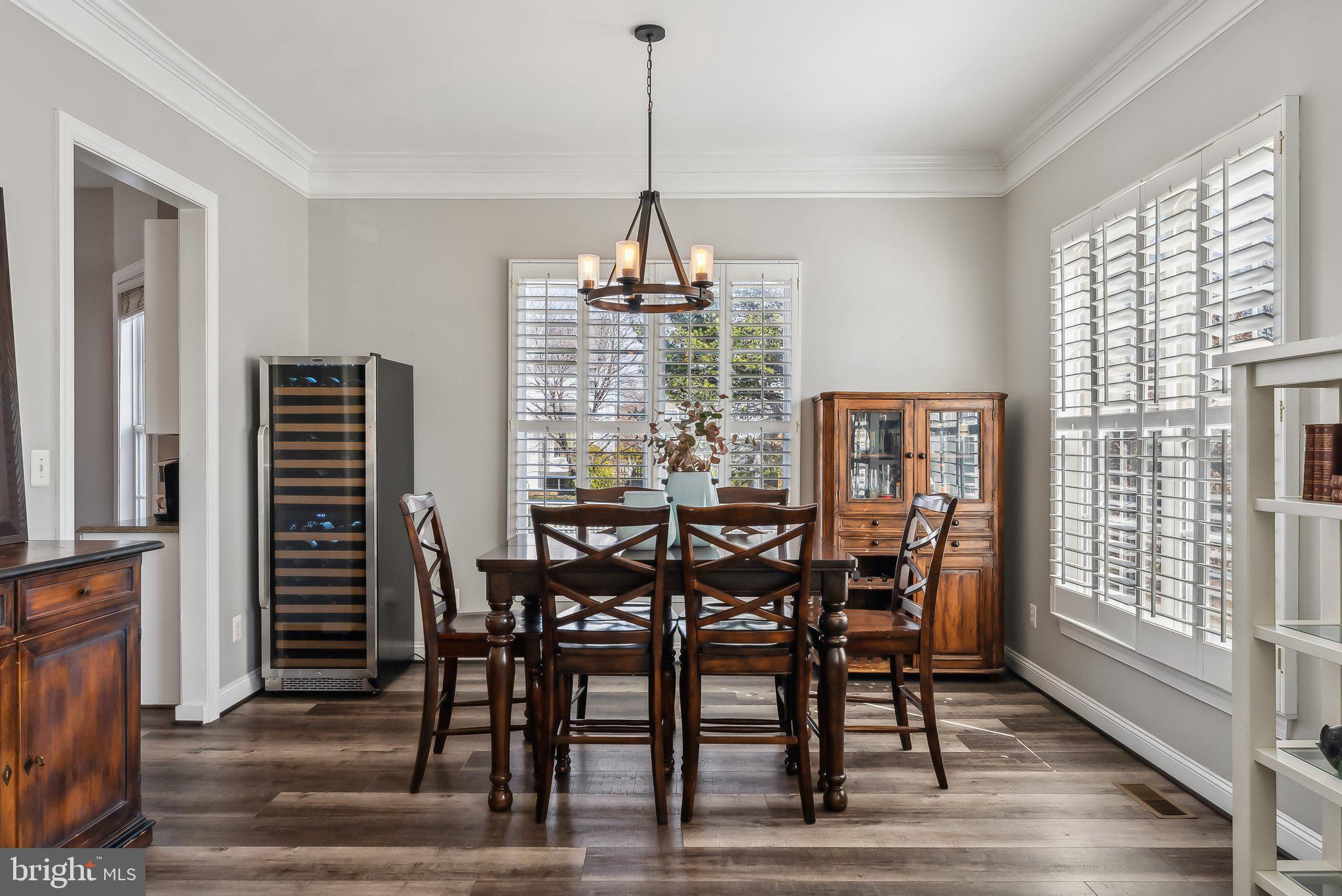 9061 Roaring Spring Loop Bristow, VA 20136 - Photo 8 of 55 a view of a dining room with furniture window and wooden floor