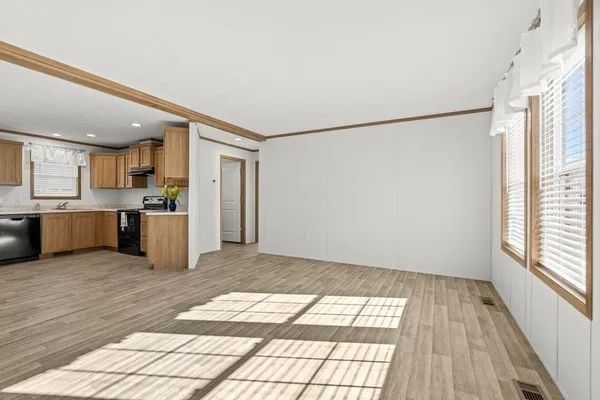 a view of a kitchen with wooden floor and a refrigerator
