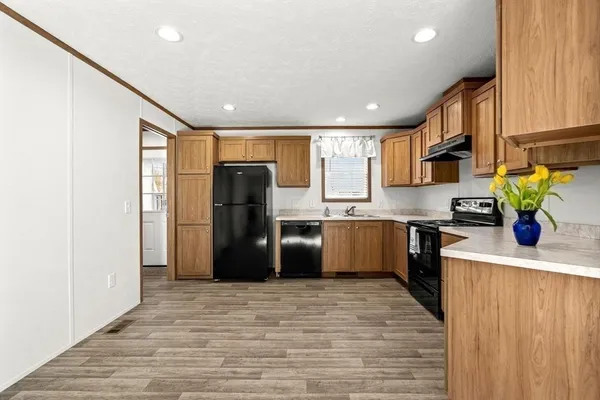 a kitchen with a refrigerator and a sink