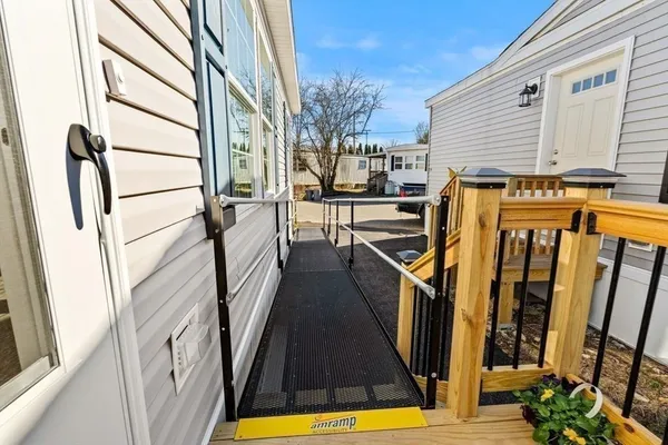 a view of a balcony with wooden floor and iron stairs