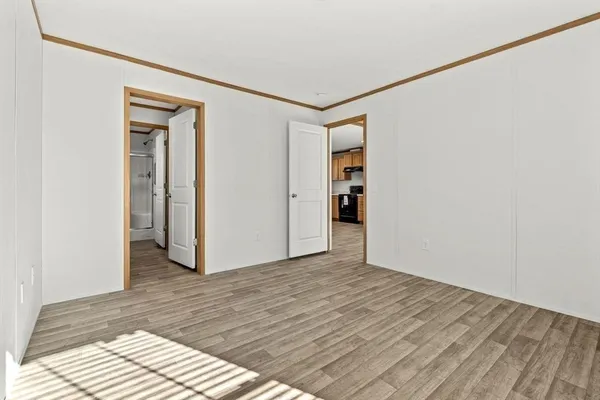 a view of a room with wooden floor and closet