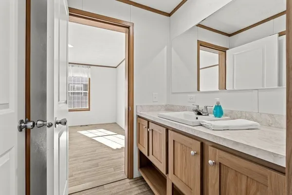 a bathroom with a granite countertop sink a mirror and a bathtub