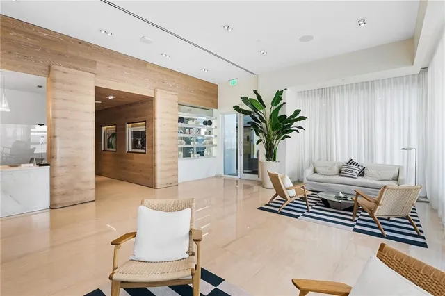 a living room with furniture flowerpot and wooden floor