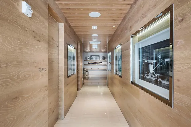 a view of a hallway with stainless steel appliances granite countertop furniture and a fireplace