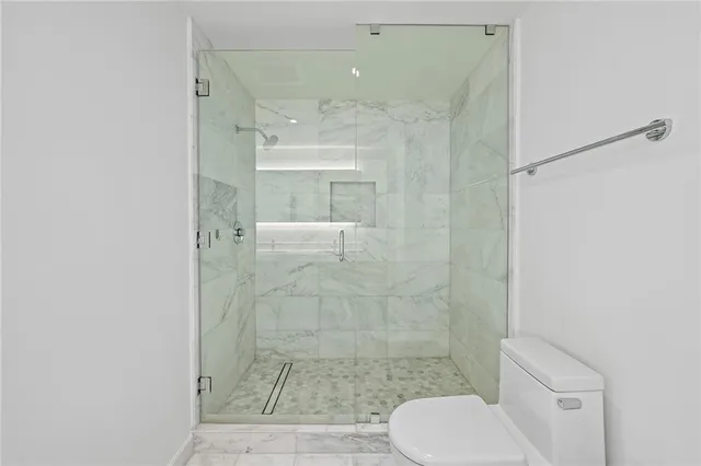 a bathroom with a shower and toilet