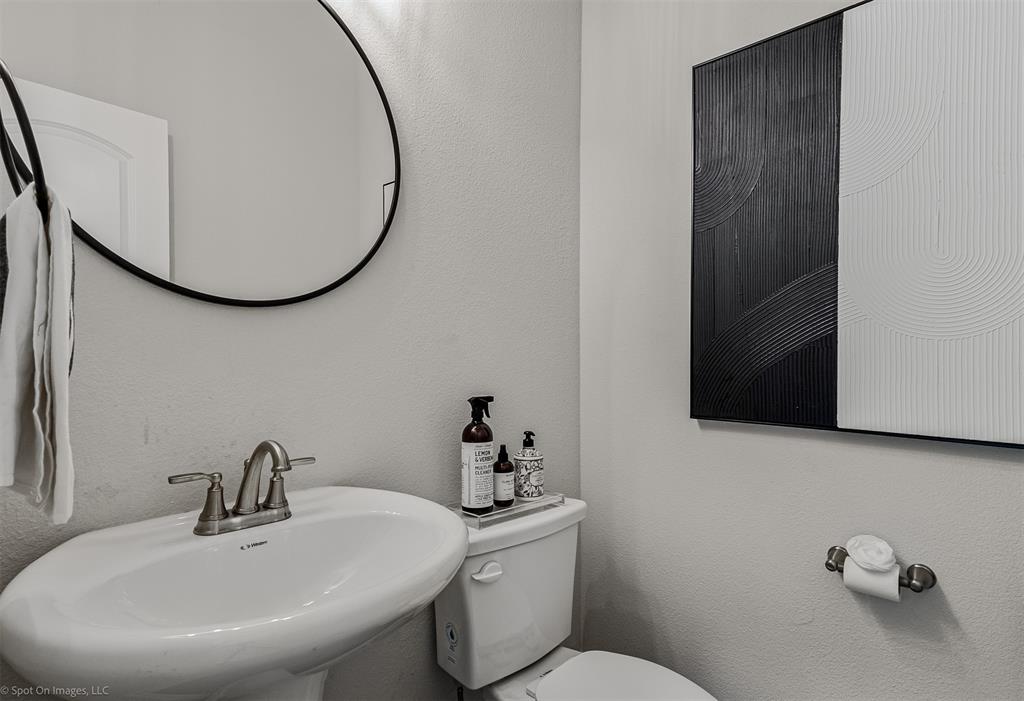 6513 Earley Way Forney, TX 75126 - Photo 19 of 36 a bathroom with a sink a mirror and a toilet