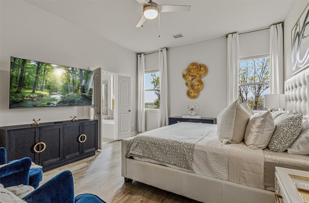 6513 Earley Way Forney, TX 75126 - Photo 20 of 36 a bedroom with a bed and a flat screen tv