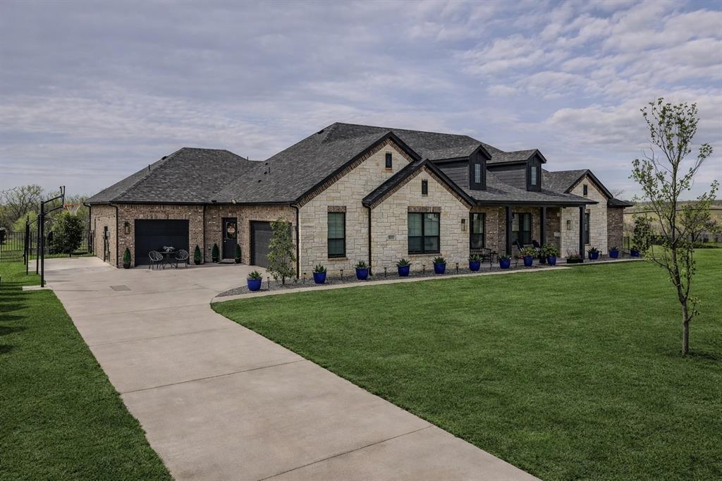 6513 Earley Way Forney, TX 75126 - Photo 2 of 36 a front view of a house with a garden and porch