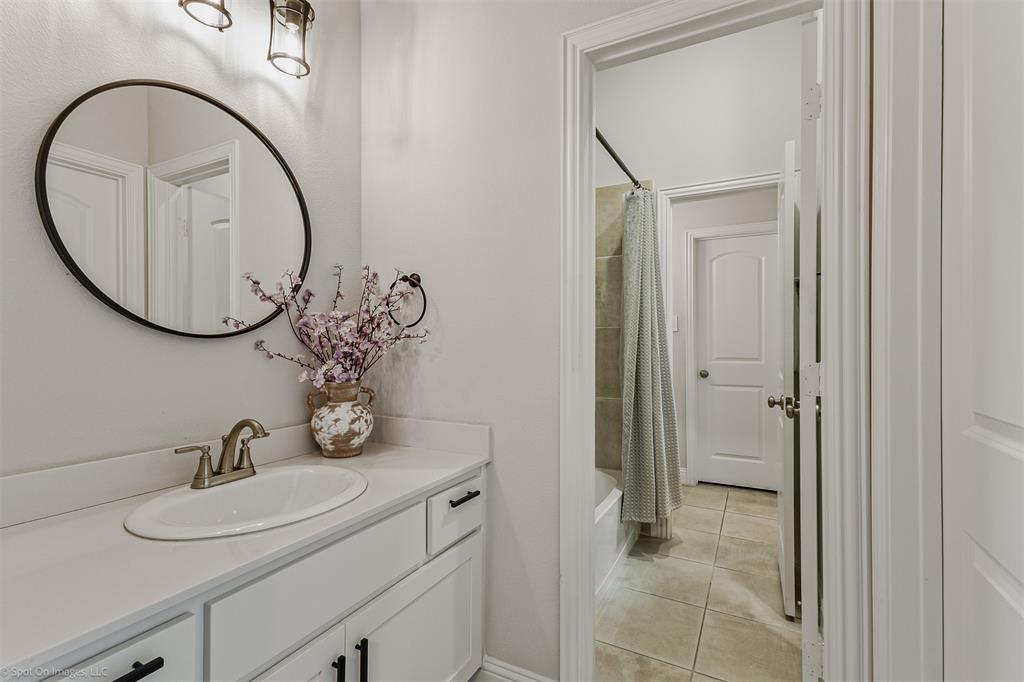 6513 Earley Way Forney, TX 75126 - Photo 24 of 36 a bathroom with a sink and a mirror