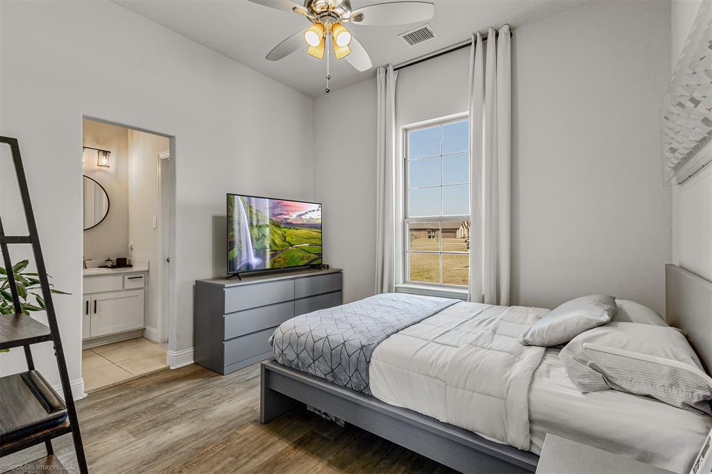 6513 Earley Way Forney, TX 75126 - Photo 25 of 36 a bedroom with a bed and a flat screen tv