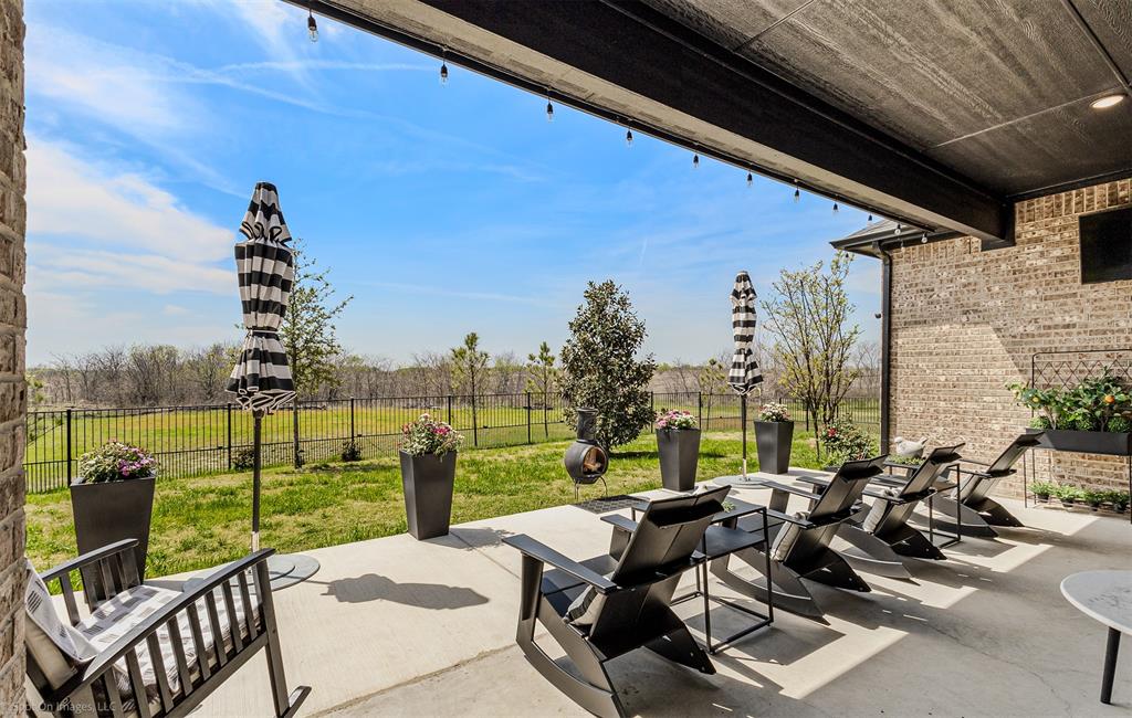 6513 Earley Way Forney, TX 75126 - Photo 31 of 36 a view of a patio with lawn chairs floor to ceiling window and lake view