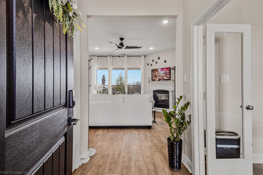6513 Earley Way Forney, TX 75126 - Photo 8 of 36 a room with kitchen island a potted plant and stainless steel appliances