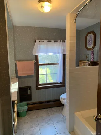 an empty room with wooden floor and closet