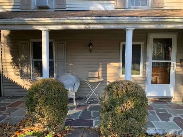 a view of front of house with a yard