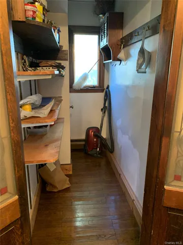 a living room with a flat screen tv and a washer dryer