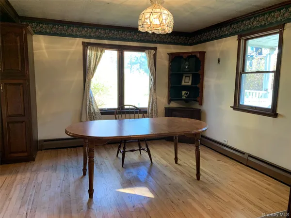a view of a dining room with furniture and wooden floor