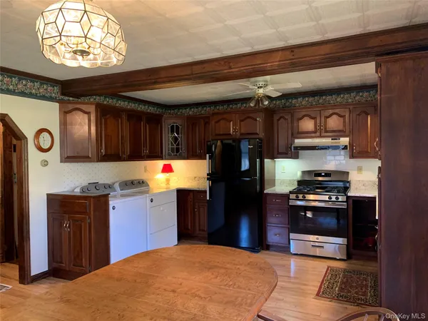 a kitchen with stainless steel appliances granite countertop a refrigerator stove and sink