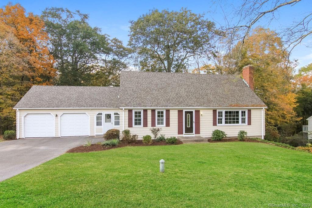 a front view of house with yard and green space