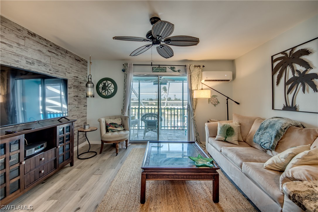 3215 Stringfellow Road, Unit 2D St. James City, FL 33956 - Photo 12 of 39 a living room with furniture and a fireplace