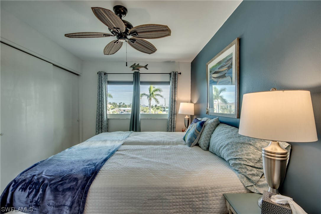 3215 Stringfellow Road, Unit 2D St. James City, FL 33956 - Photo 16 of 39 a bedroom with a bed dresser and a window
