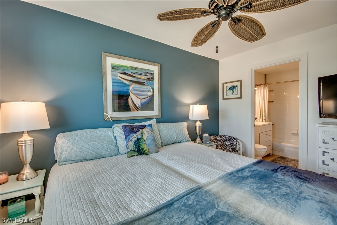 3215 Stringfellow Road, Unit 2D St. James City, FL 33956 - Photo 17 of 39 a bedroom with a bed and lamp