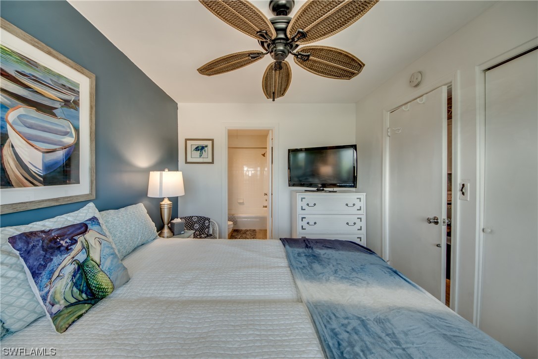 3215 Stringfellow Road, Unit 2D St. James City, FL 33956 - Photo 18 of 39 a bedroom with a bed and a flat screen tv