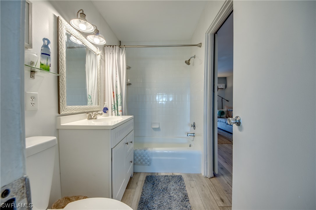 3215 Stringfellow Road, Unit 2D St. James City, FL 33956 - Photo 19 of 39 a bathroom with a granite countertop sink toilet and shower