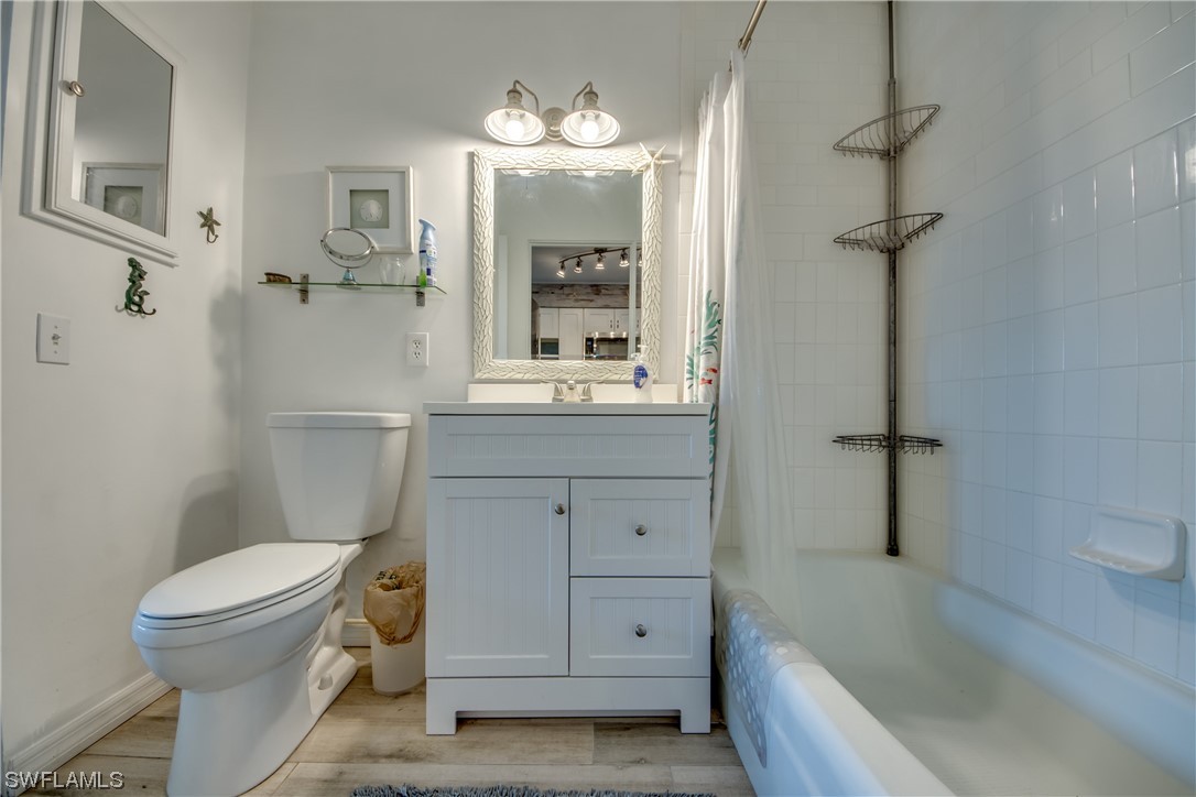 3215 Stringfellow Road, Unit 2D St. James City, FL 33956 - Photo 20 of 39 a bathroom with a sink a toilet and shower