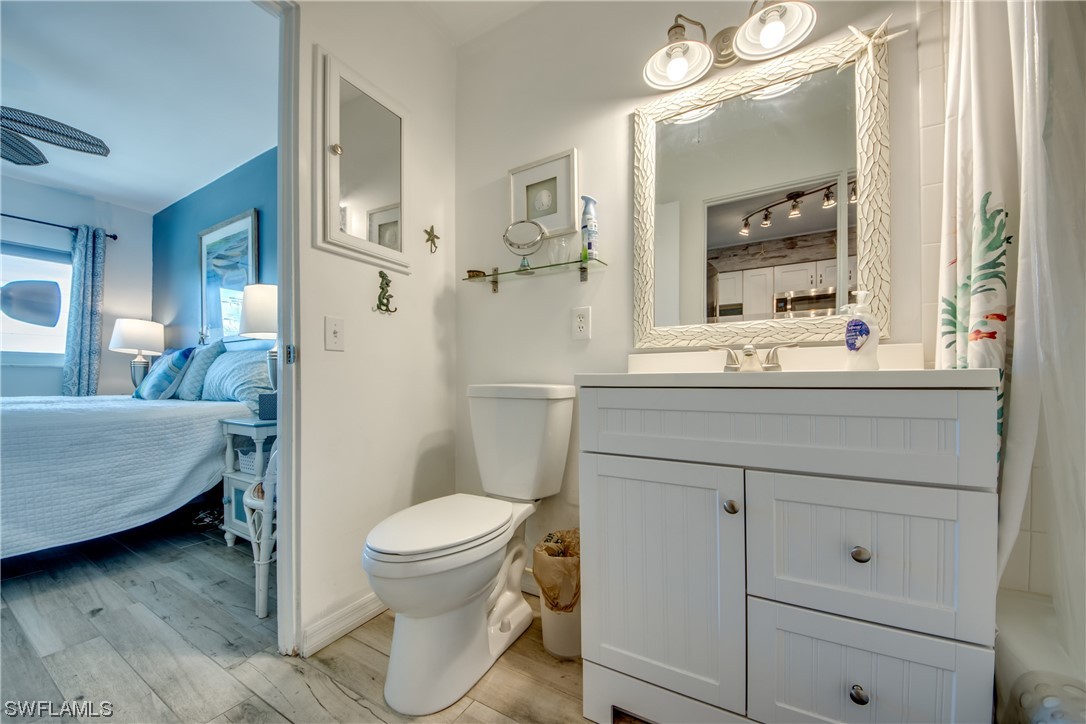 3215 Stringfellow Road, Unit 2D St. James City, FL 33956 - Photo 21 of 39 a bathroom with a sink a toilet and a mirror