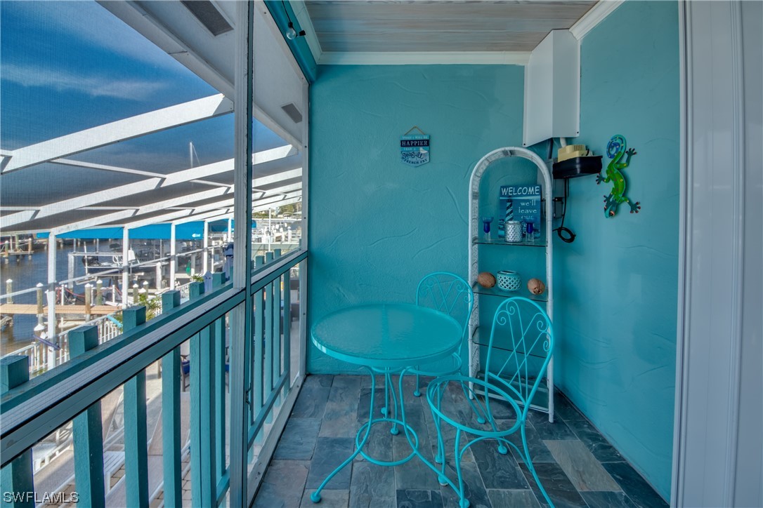 3215 Stringfellow Road, Unit 2D St. James City, FL 33956 - Photo 26 of 39 a balcony with table and chairs