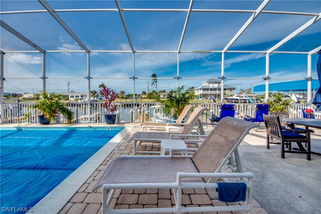 3215 Stringfellow Road, Unit 2D St. James City, FL 33956 - Photo 29 of 39 a view of a chairs and tables in patio