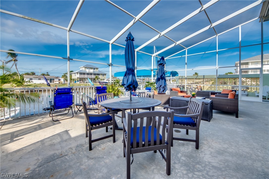 3215 Stringfellow Road, Unit 2D St. James City, FL 33956 - Photo 30 of 39 a view of a tables and chairs in patio
