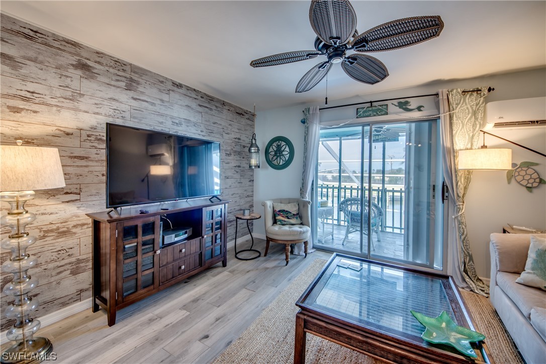 3215 Stringfellow Road, Unit 2D St. James City, FL 33956 - Photo 3 of 39 a living room with furniture and a flat screen tv