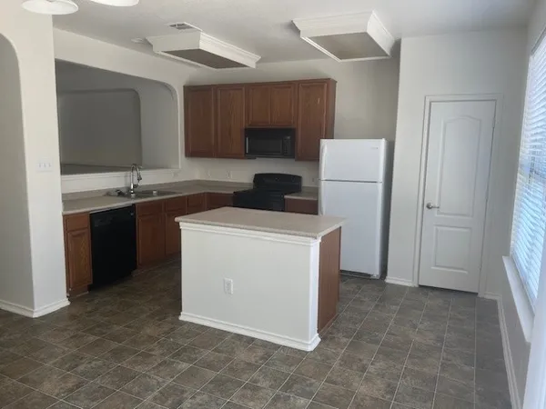 a kitchen with a sink stove and cabinets