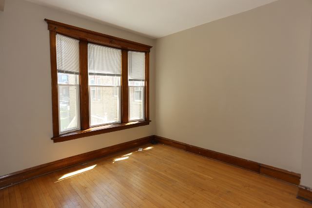 2312 West Iowa Street, Unit 1R Chicago, IL 60622 - Photo 11 of 20 an empty room with wooden floor and windows