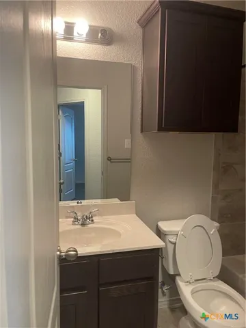 a bathroom with a sink toilet and mirror