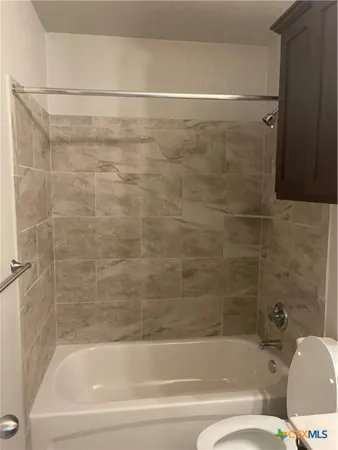 a bathroom with a bathtub and a toilet