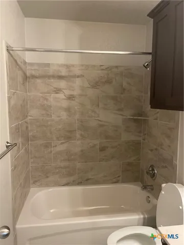 a bathroom with a bathtub and a toilet