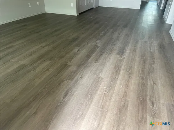 a view of wooden floor and brick walls