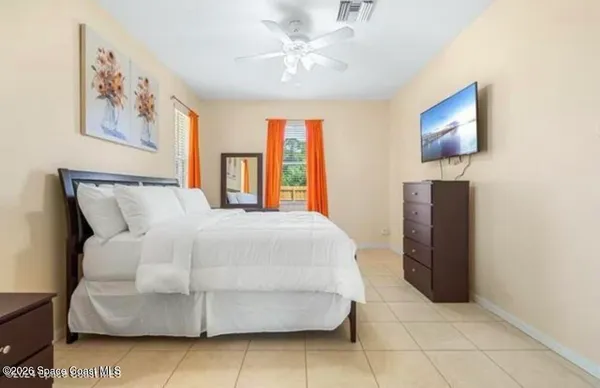a bedroom with a bed and a painting on the wall