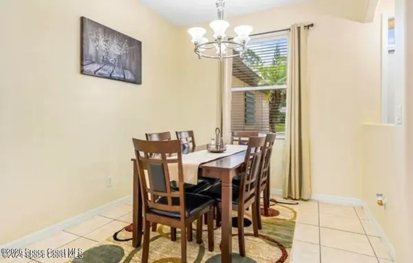 a view of a dining room with furniture and a chandelier