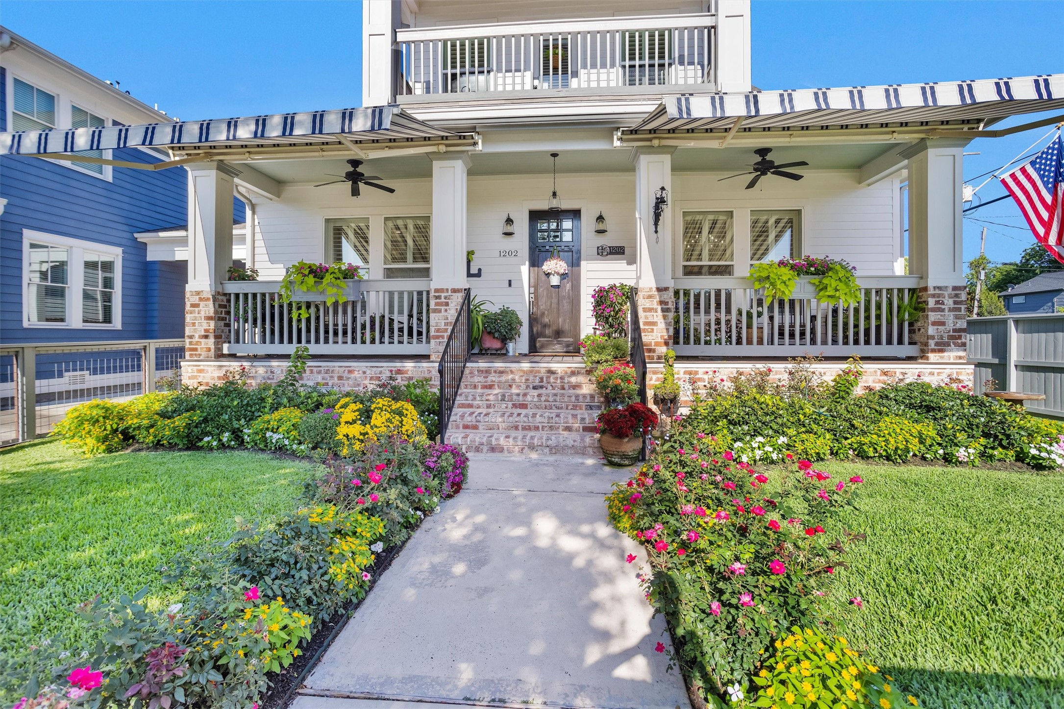 1202 Walton Street Houston, TX 77009 - Photo 30 of 32 Beautifully Landscaped Front Yard Showcasing Vibrant Flowers, Mature Plantings, and Exceptional Curb Appeal That Makes This Home Truly Stand Out.