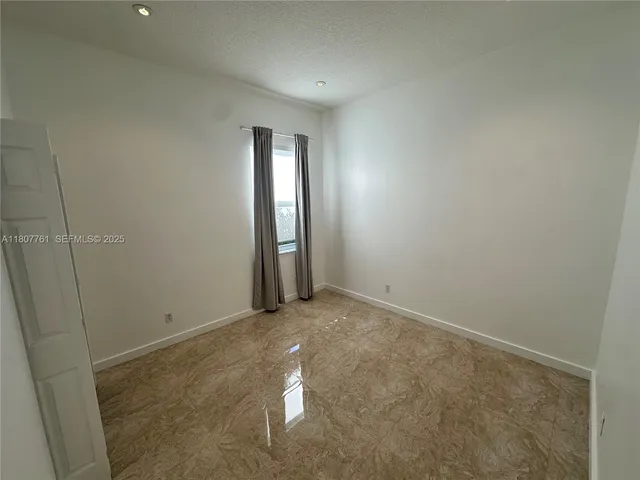 front view of a house with a tree