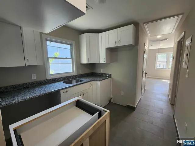 a view of a room with wooden floor and bathroom