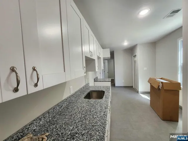 a large room with a lot of couch and mirrors