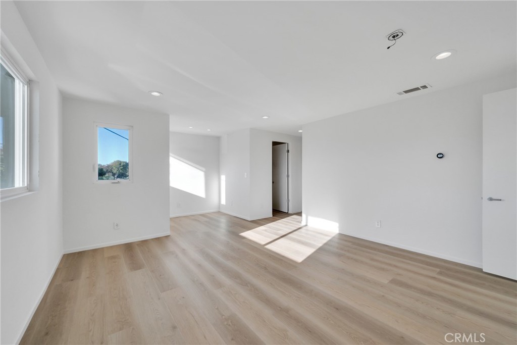 514 Ardmore Avenue Hermosa Beach, CA 90254 - Photo 19 of 54 an empty room with wooden floor and windows